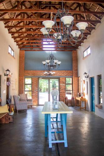 a large room with a table and a chandelier at Bel Tramonto in Bloemfontein