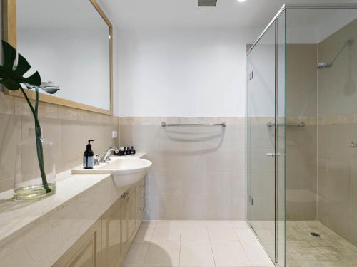 a bathroom with a sink and a glass shower at Koonya Paradise in Sorrento