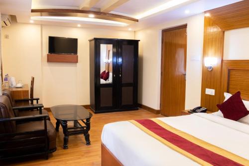 
a hotel room with a bed and a tv at Everland Kathmandu Hotel in Kathmandu
