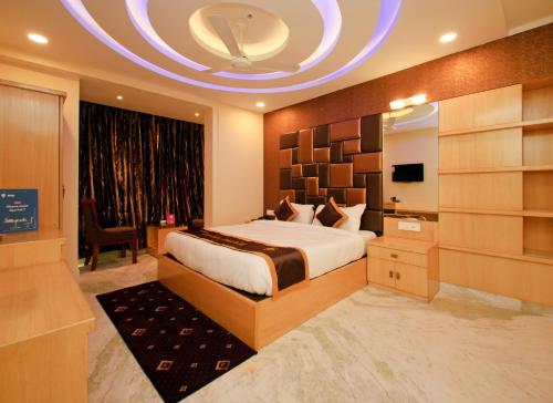 a bedroom with a large bed and a large window at Hotel Golden Palace in Kolkata