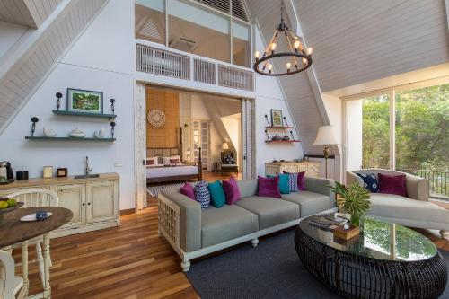 a living room with a couch and a table at Plataran Menjangan Resort and Spa - CHSE Certified in Banyuwedang