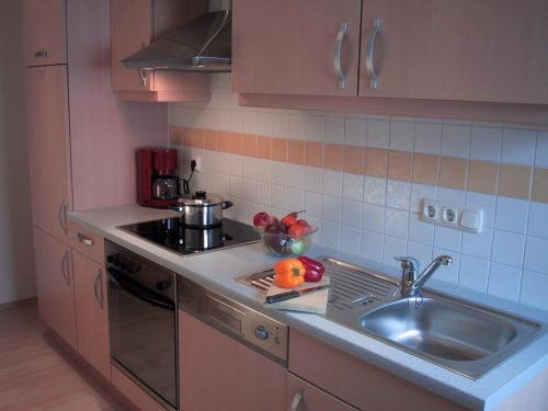 a kitchen with a sink and a stove and a sink at Antares am See in Maurach
