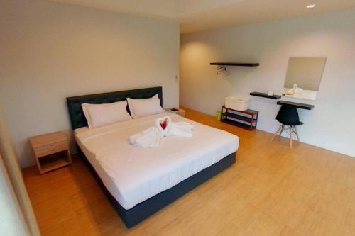 a bedroom with a bed with a towel on it at Oon Valley Farm Stay in Ban Mae Pha Haen