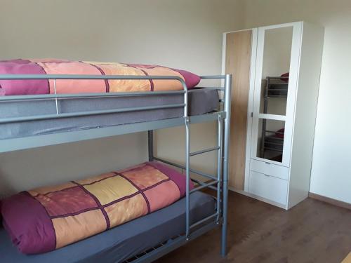 a bunk bed room with two bunk beds and a mirror at Ferienwohnung Radebeul Self Check-in in Radebeul
