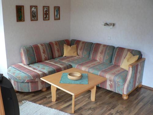 a living room with a couch and a table at Antares am See in Maurach