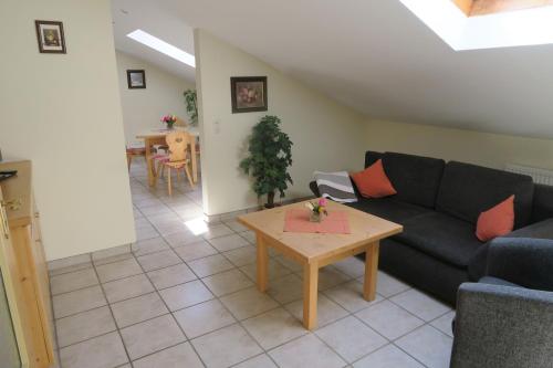 a living room with a couch and a table at Gasthof Tiroler Hof in Bad Feilnbach