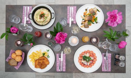 a table with plates of food on it at Hotel-Restaurant Gollner in Lebring