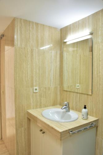 a bathroom with a sink and a mirror at BEACH SIDE in Puerto de Mogán