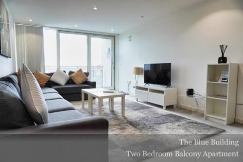 a living room with a couch and a tv at Gunwharf Quays Apartments in Portsmouth