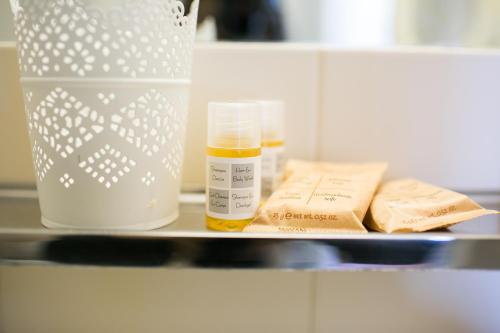 a shelf with a bottle and some medicines on it at Rex Hotel Residence in Genova