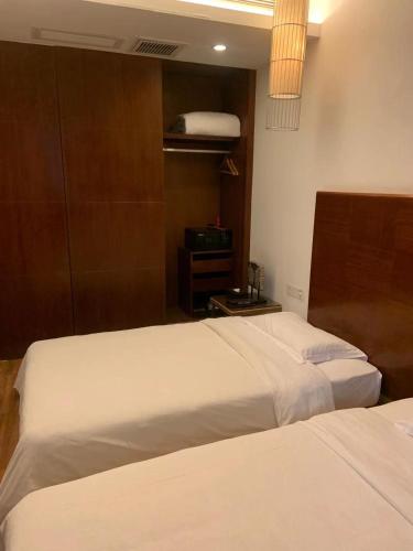 two beds in a hotel room with two beds sidx sidx sidx at Guangzhou Fangyuan Hotel - Free Shuttle Bus to Canton Fair Complex during 14th Oct to 3rd Nov in Guangzhou