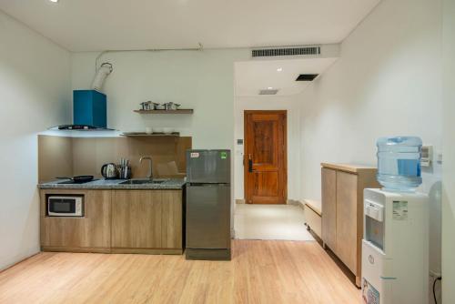 a kitchen with a sink and a refrigerator at 22HOUSING 48 Phan Kế Bính in Hanoi