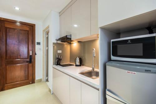 a kitchen with a sink and a microwave at 22HOUSING 48 Phan Kế Bính in Hanoi