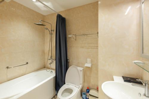 a bathroom with a tub and a toilet and a sink at 22HOUSING 48 Phan Kế Bính in Hanoi