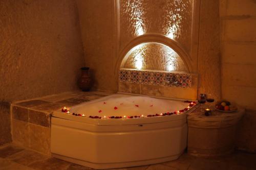 a bath tub with christmas lights in a bathroom at Asteria Cave Hotel in Goreme