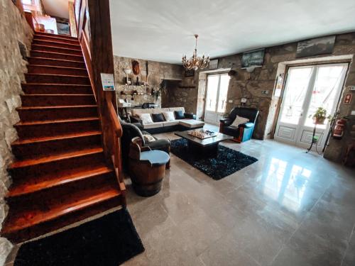 a living room with a staircase and a living room with a couch at Casa da Tanquinha in Beiral do Lima
