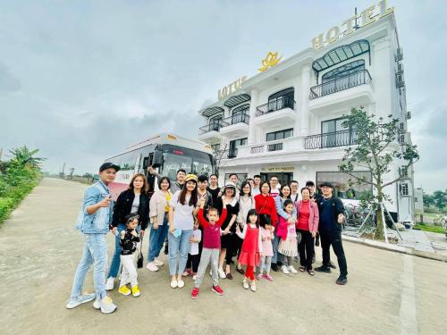a group of people posing for a picture in front of a building at Lotus Hotel Ninh Bình in Ninh Binh