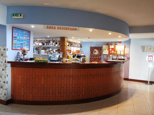 a bar in a restaurant with a counter at ''O Veleiro'' Rest. Resid. in Torreira