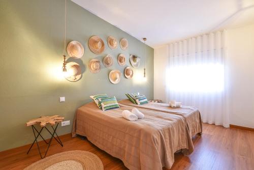 a bedroom with a bed with plates on the wall at Salema Eco Camp - Sustainable Camping & Glamping in Salema