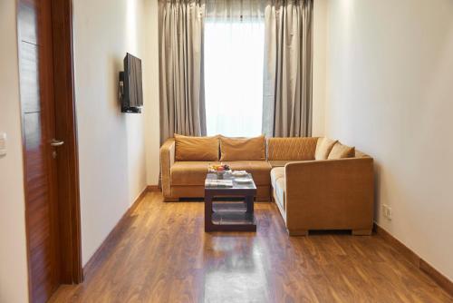 a living room with a couch and a table at The P L Palace Agra in Agra