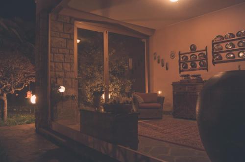 a living room with a chair and a glass door at LA MOIA in Cerete