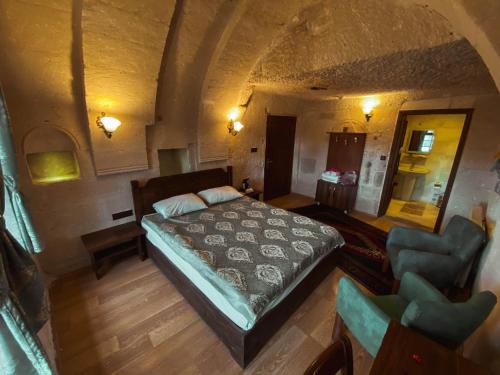 an overhead view of a bedroom with a bed and a chair at Asteria Cave Hotel in Goreme