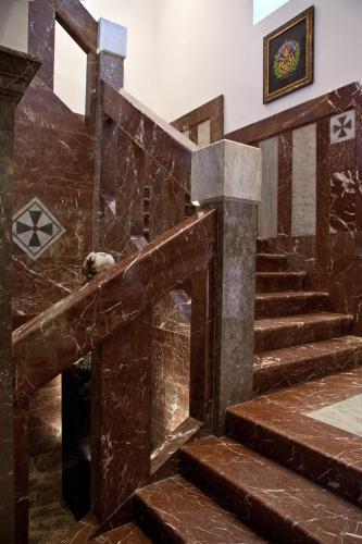 a staircase in a building with a dog sitting on it at The Ashbee Hotel in Taormina