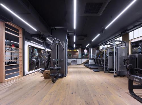 a gym with a row of treadms and machines at Wellington Hotel & Spa Madrid in Madrid