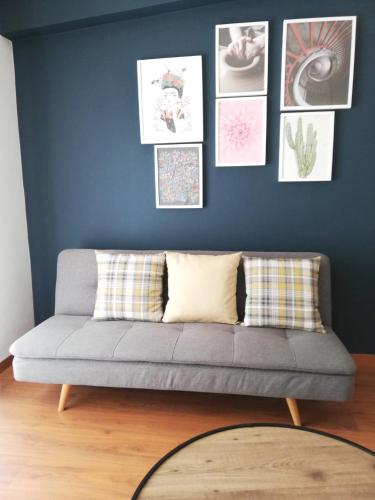 a couch in a living room with pictures on the wall at Salema Eco Camp - Sustainable Camping & Glamping in Salema