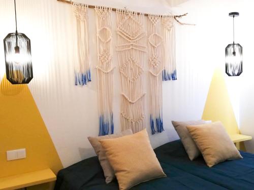 a bedroom with a bed with blue and white curtains at Salema Eco Camp - Sustainable Camping & Glamping in Salema