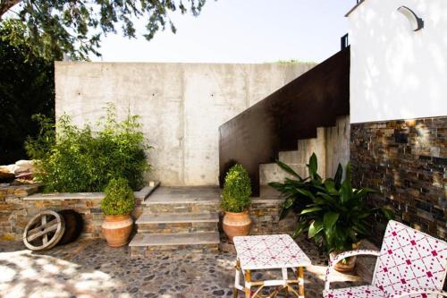 a patio with some plants and a staircase at Molino Candeal Hotel Boutique & Apartamentos in Caniles