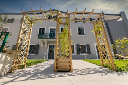 a wooden archway in front of a building at Residence La Torre con private park in Trieste