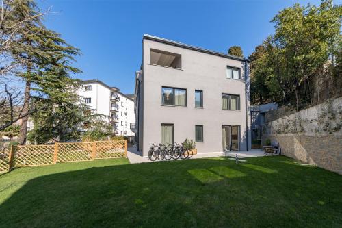 an exterior view of a white building with a yard at Residence La Torre con private park in Trieste