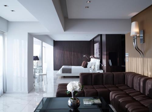 a living room with a couch and a bed at Aqua Blu Boutique Hotel & Spa, Adults Only- Small Luxury Hotels of the World in Kos