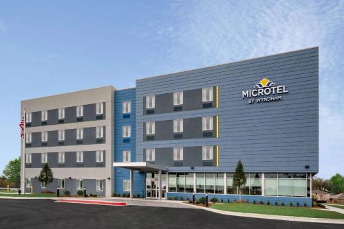 an office building with a mulriott sign on it at Microtel Inn & Suites by Wyndham Hot Springs in Hot Springs