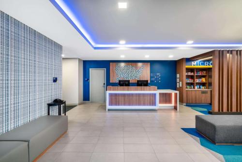 a lobby of a mica store with blue walls at Microtel Inn & Suites by Wyndham Hot Springs in Hot Springs