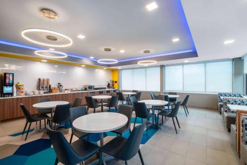 a restaurant with tables and chairs and a counter at Microtel Inn & Suites by Wyndham Hot Springs in Hot Springs