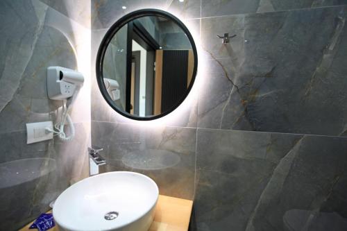 a bathroom with a sink and a mirror at Hotel Citrus in Ksamil