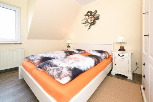 Postel nebo postele na pokoji v ubytování Ferienhaus Nordseeidyll