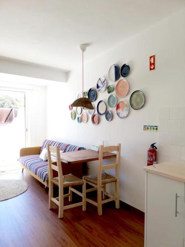 a dining room with a table and plates on the wall at Salema Eco Camp - Sustainable Camping & Glamping in Salema