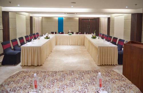 a large meeting room with two tables and chairs at The P L Palace Agra in Agra