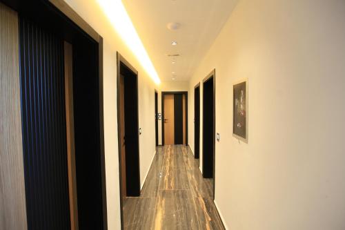 a hallway of a building with wooden floors and doors at Hotel Citrus in Ksamil