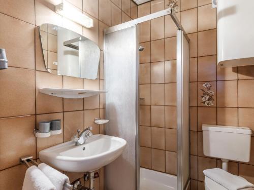 a small bathroom with a sink and a toilet at Pension Konrad in Söll