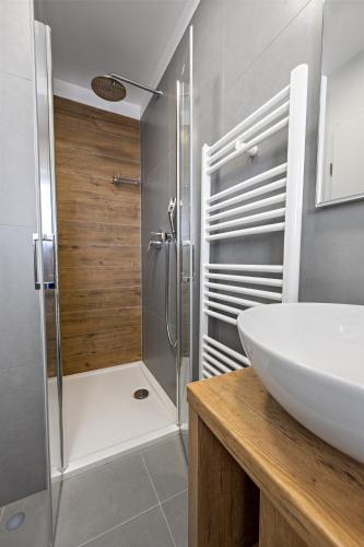a bathroom with a shower and a white sink at Aquarelle Apartments Primošten apt no 1 and 3 in Primošten