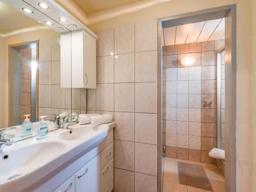 a bathroom with a sink and a shower at Pension Konrad in Söll