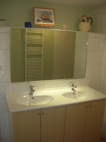 a bathroom with a sink and a mirror at Gîte - La Rigaudière in Le Theil-de-Bretagne
