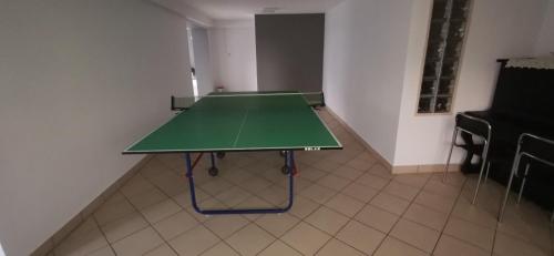 a green ping pong table in a room at Dom Wczasowy Irys in Węgierska Górka