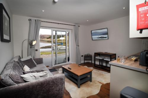 a living room with a couch and a table at Scorr House Apartment in Portree