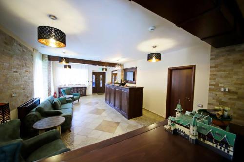 a living room with a couch and a table at Montebello in Predeal