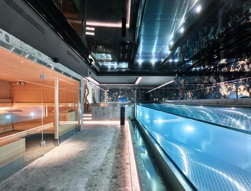a large swimming pool in a building with a swimming pool at Wellington Hotel & Spa Madrid in Madrid